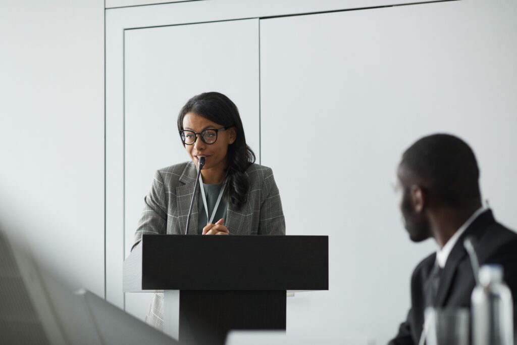 Professional woman speaking at a conference lectern